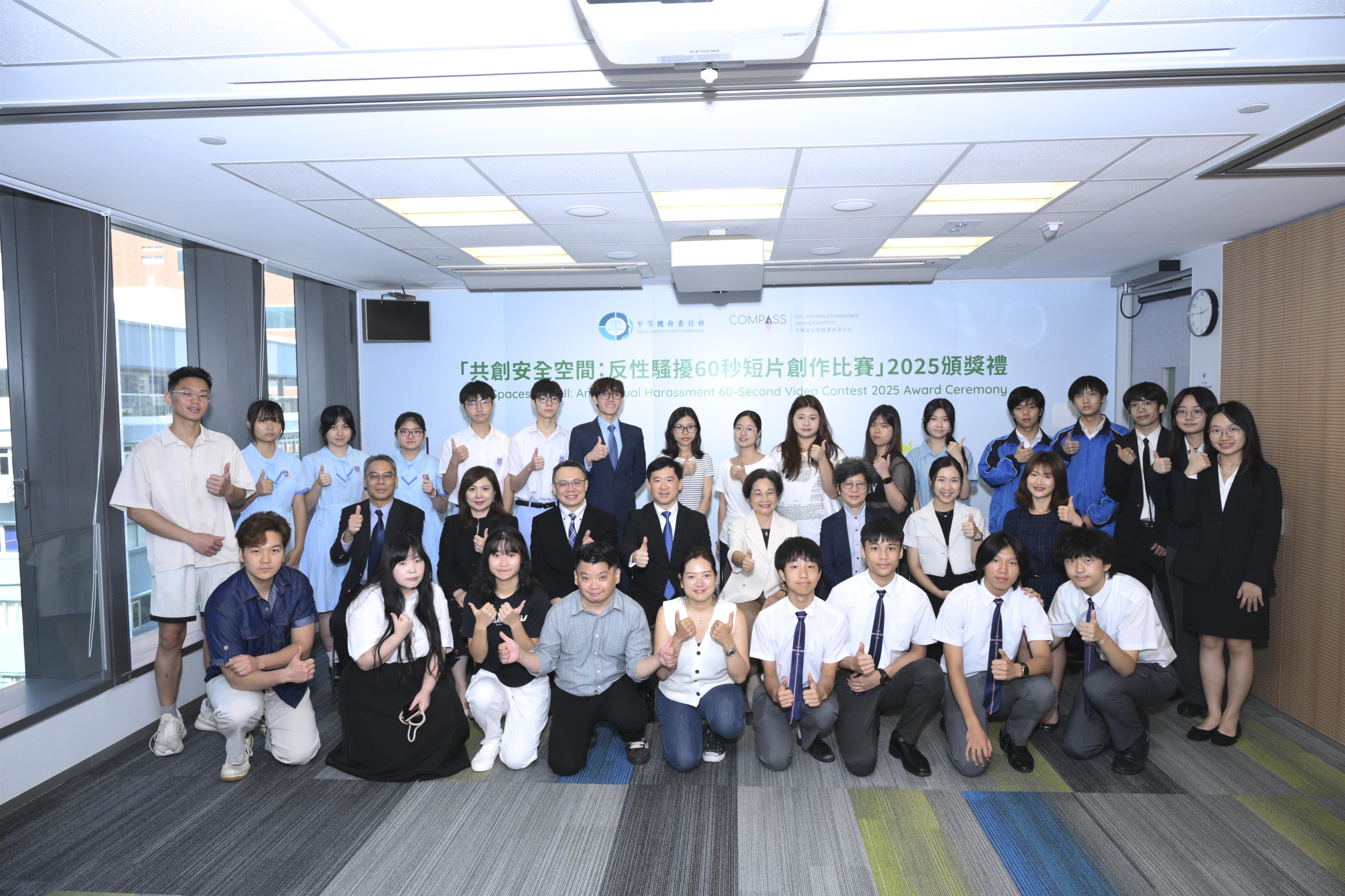 A group photo of the guests and winners at the award presentation ceremony for the “Safe Spaces for All: Anti-Sexual Harassment 60-Second Video Contest” in front of the backdrop.